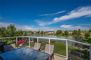 a patio overlooking a manmade lake in summer