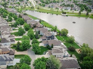 a neighbourhood showing homes surrounding a man-made lake